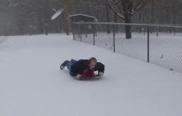 Linda on sled in SNOW!
